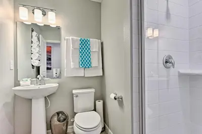 a bathroom with a toilet and a sink and a shower at Theme Park Retreat with 5-Star Amenities - By Disney in Kissimmee