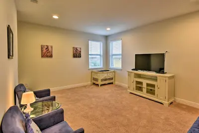 a living room with a flat screen tv and chairs at 5 Mi to Disney Oasis with Pool and Patio in Orlando
