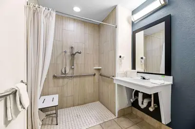 a bathroom with a sink and a shower at Suburban Studios Orlando - Ocoee-Winter Garden in Orlando