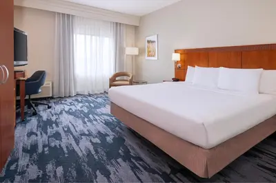a hotel room with a large bed and a desk at Fairfield Inn & Suites Orlando Ocoee in Orlando