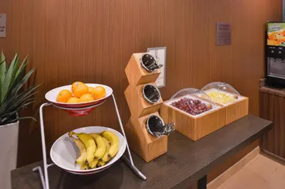 a counter with a bowl of fruit and a bowl of oranges at Fairfield Inn & Suites Orlando Ocoee in Orlando
