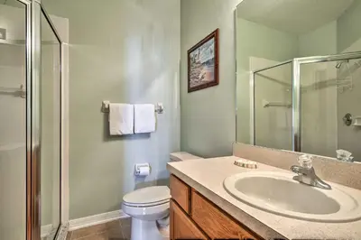 a bathroom with a sink and a toilet and a shower at 10 Mi to Disney Resort Home with Pool and Spa in Orlando