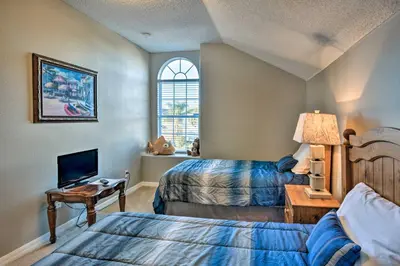 a bedroom with two beds and a tv in it at 10 Mi to Disney Resort Home with Pool and Spa in Orlando