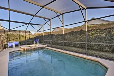 a swimming pool with a view of a mountain at 10 Mi to Disney Resort Home with Pool and Spa in Orlando