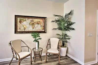 a room with two chairs and a painting on the wall at Kissimmee Retreat with Pool Access Less Than 4 Mi to Disney! in Orlando