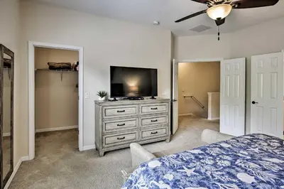 a bedroom with a bed and a television on a dresser at Kissimmee Retreat with Pool Access Less Than 4 Mi to Disney! in Orlando
