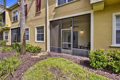a house with sliding glass doors in a yard at Kissimmee Retreat with Pool Access Less Than 4 Mi to Disney! in Orlando
