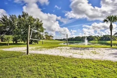 a volley ball net in a park with a fountain at Kissimmee Retreat with Pool Access Less Than 4 Mi to Disney! in Orlando