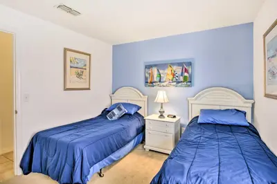 two beds in a bedroom with blue walls at Retreat with Pool 25 Mi to Disney in Kissimmee