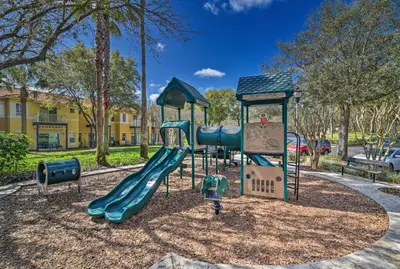 a playground with a slide in a park at Retreat with Pool 25 Mi to Disney in Kissimmee