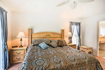 a bedroom with a large bed and two lamps at Retreat with Pool 25 Mi to Disney in Kissimmee