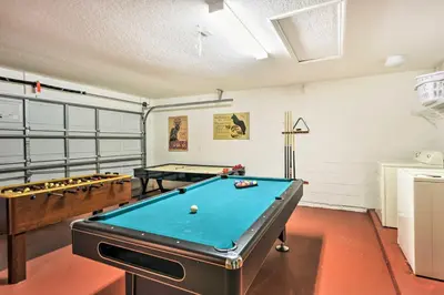 a room with a pool table and two billards at Retreat with Pool 25 Mi to Disney in Kissimmee