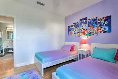 a bedroom with two beds and a painting on the wall at Lovely Resort Condo Near Disney, Golf and Dining! in Kissimmee