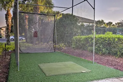 a batting cage with a net and some grass at Lovely Resort Condo Near Disney, Golf and Dining! in Kissimmee