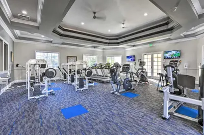 a fitness room with treadmills and cardio machines at Lovely Resort Condo Near Disney, Golf and Dining! in Kissimmee