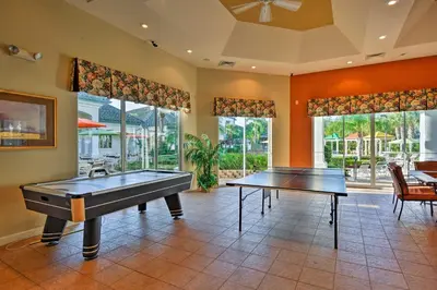 a large room with two ping pong tables in it at Lovely Resort Condo Near Disney, Golf and Dining! in Kissimmee