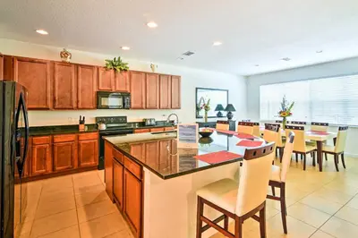 a large kitchen with a table and chairs in it at Home with Private Pool and Spa 8 Mi to Disney in Kissimmee