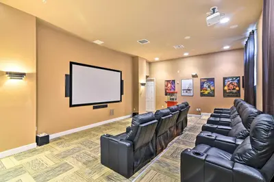 a waiting room with leather chairs and a flat screen tv at Home with Private Pool and Spa 8 Mi to Disney in Kissimmee