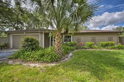 a palm tree in front of a house at Pet-Friendly Apopka Home 30 Mi to WDW! in Orlando