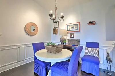 a dining room with blue chairs and a table at Resort-Style Condo with Pool 6 Mi to Magic Kingdom in Kissimmee