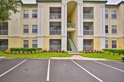 an empty parking lot in front of a building at Resort-Style Condo with Pool 6 Mi to Magic Kingdom in Kissimmee