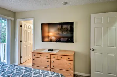 a bedroom with a dresser and a painting on the wall at 5 Mi to Disney Emerald Island Resort Condo! in Kissimmee