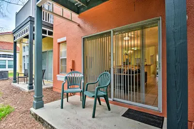 two chairs sitting on a patio outside of a house at 5 Mi to Disney Emerald Island Resort Condo! in Kissimmee