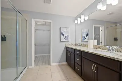 a bathroom with two sinks and a shower at 4 Mi to Dtwn Home with Pool Access in Sanford in Sanford