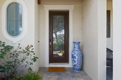 a blue and white vase sitting in front of a door at 4 Mi to Dtwn Home with Pool Access in Sanford in Sanford