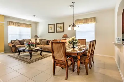a kitchen and living room with a table and chairs at Spacious Kissimmee Villa - 3 Mi to Disney World! in Orlando