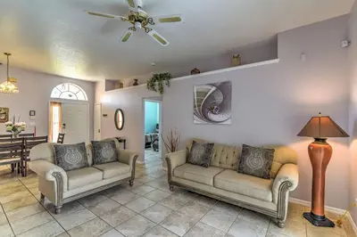 a living room with two couches and a ceiling fan at Kissimmee Retreat with Pool Near Disney and Golf! in Kissimmee