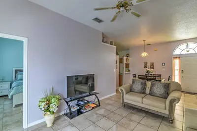 a living room with a couch and a fireplace at Kissimmee Retreat with Pool Near Disney and Golf! in Kissimmee