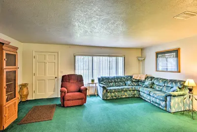a living room with a couch and a chair at Sandford Vacation Rental Near Airport and Lake! in Sanford