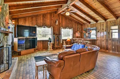 a living room with a couch and a flat screen tv at Sandford Vacation Rental Near Airport and Lake! in Sanford