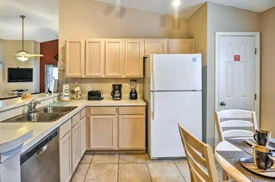 a kitchen with a white refrigerator and a table at Clermont Home with Pool and Game Room 10 Mi to Parks! in Orlando