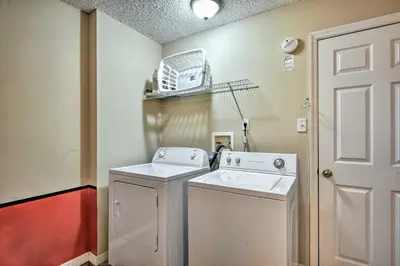 a small laundry room with a washer and dryer at Clermont Home with Pool and Game Room 10 Mi to Parks! in Orlando