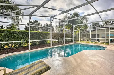 a swimming pool in a house with a glass ceiling at Clermont Home with Pool and Game Room 10 Mi to Parks! in Orlando