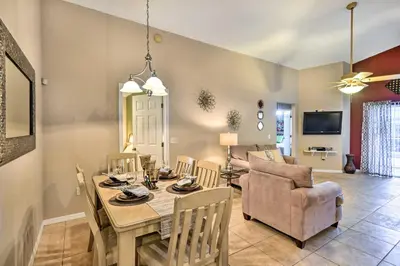 a dining room and living room with a table and chairs at Clermont Home with Pool and Game Room 10 Mi to Parks! in Orlando