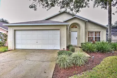 a house with a white garage at Clermont Home with Pool and Game Room 10 Mi to Parks! in Orlando