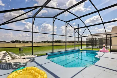 a swimming pool in a glass house with a view at 5 Mi to Disney Parks Kissimmee Home with Game Room in Kissimmee