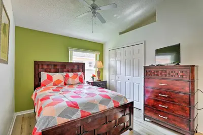 a bedroom with a bed and a dresser at 5 Mi to Disney Parks Kissimmee Home with Game Room in Kissimmee