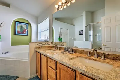 a bathroom with two sinks and a tub and a shower at 5 Mi to Disney Parks Kissimmee Home with Game Room in Kissimmee