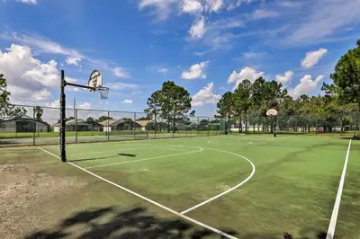 a tennis court with a basketball hoop on it at 5 Mi to Disney Parks Kissimmee Home with Game Room in Kissimmee