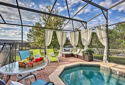 a patio with a pool and a table and chairs at 4 Mi to Animal Kingdom Gem with Pool in Kissimmee in Kissimmee