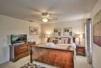 a bedroom with a bed and a ceiling fan at 4 Mi to Animal Kingdom Gem with Pool in Kissimmee in Kissimmee