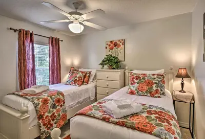 a bedroom with two beds and a ceiling fan at 4 Mi to Animal Kingdom Gem with Pool in Kissimmee in Kissimmee