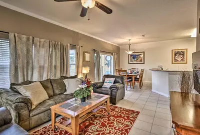 a living room with a couch and a table at 4 Mi to Animal Kingdom Gem with Pool in Kissimmee in Kissimmee