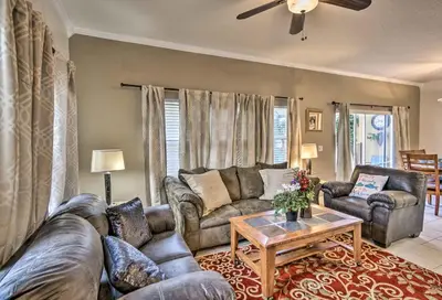 a living room with couches and a coffee table at 4 Mi to Animal Kingdom Gem with Pool in Kissimmee in Kissimmee