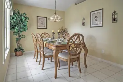 a dining room with a wooden table and chairs at Beautiful Kissimmee Home - 5 Mi to Disney World! in Kissimmee