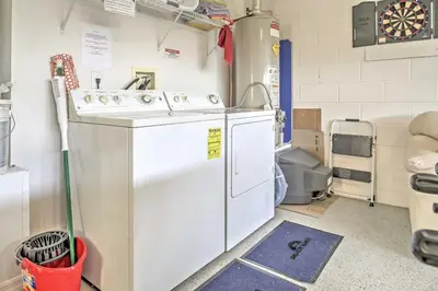 a kitchen with a washing machine and a sink at Beautiful Kissimmee Home - 5 Mi to Disney World! in Kissimmee